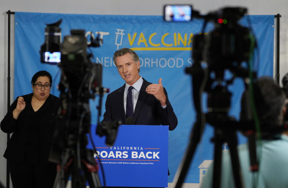 California Gov. Gavin Newsom, at podium, announces a massive jackpot as the nation's most populous state looks to encourage millions of people who are still unvaccinated to get their shots at a news conference at the Esteban E. Torres High School in Los Angeles, Thursday, May 27, 2021. California is giving away the country's largest pot of vaccine prize money — $116.5 million — in an attempt to get millions more inoculated before the most populous U.S. state fully reopens next month. Newsom announced the prizes, which also include the nation's highest single vaccine prize: $1.5 million. (AP Photo/Damian Dovarganes)