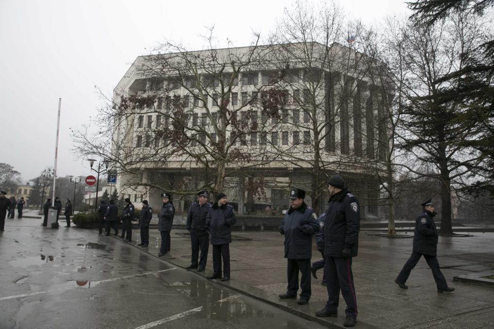 Ukrainian police stand guard in front the Crimean parliament building in Simferopol