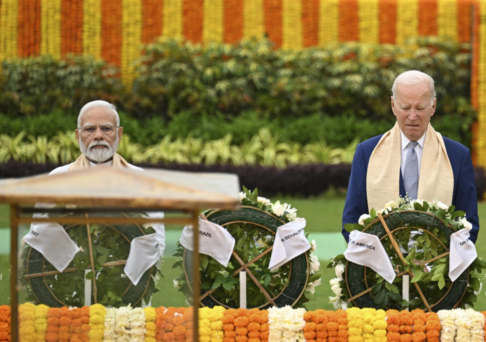 U.S. President Joe Biden, right, and Indian Prime Minister Narendra Modi pay their tributes at the Rajghat, a Mahatma Gandhi memorial, in New Delhi, India, Sunday, Sept. 10, 2023. (AP Photo/Kenny Holston, Pool)