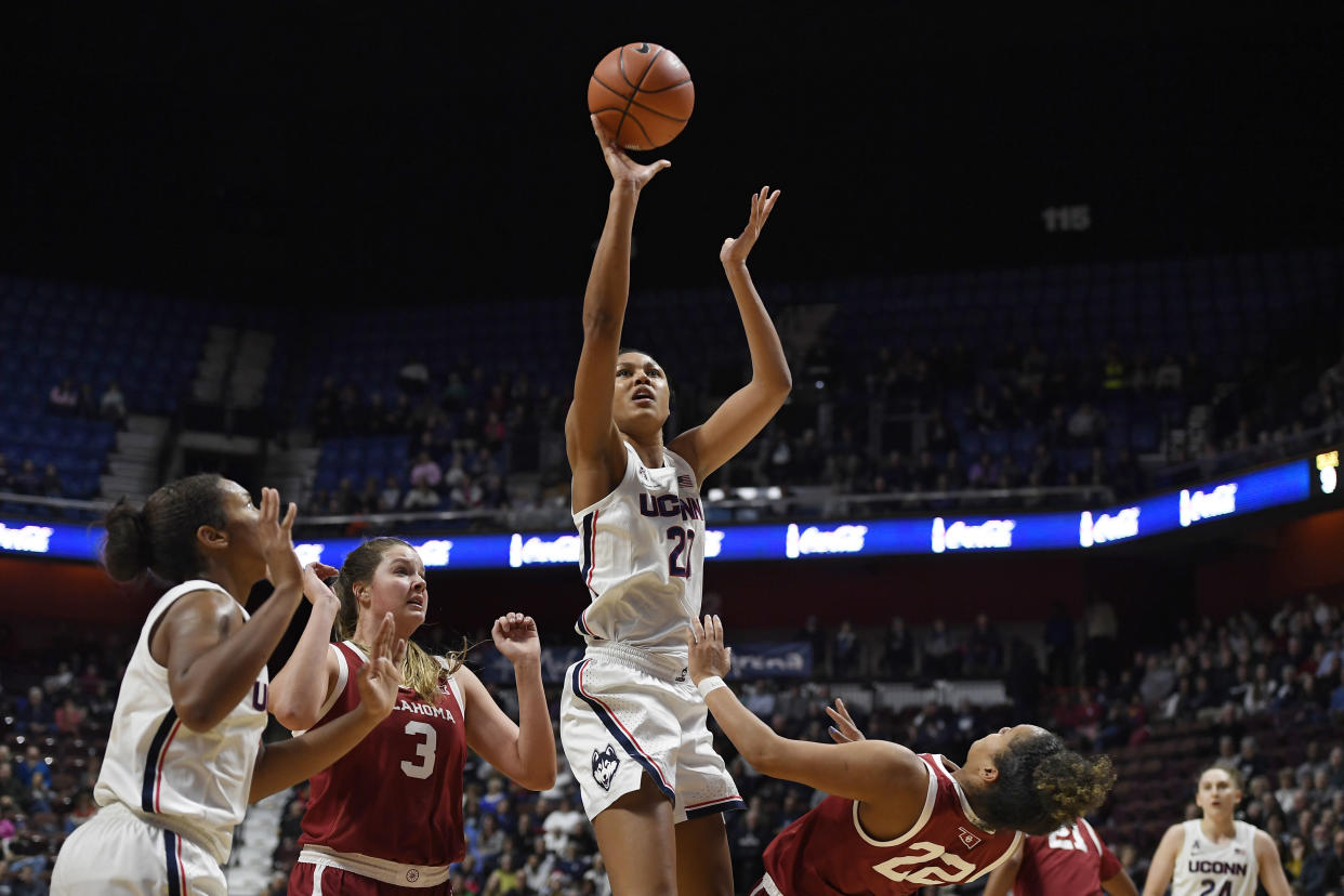 Connecticut's Olivia Nelson-Ododa (20) shoots a basket while fouled by Oklahoma's Ana Llanusa (22) in the second half of an NCAA college basketball game, Sunday, Dec. 22, 2019, in Uncasville, Conn. (AP Photo/Jessica Hill)