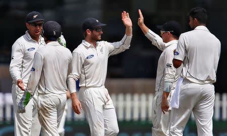 Cricket - India v New Zealand - First Test cricket match - Green Park Stadium, Kanpur, India - 25/09/2016. New Zealand's players celebrate after taking the wicket of India's Cheteshwar Pujara. REUTERS/Danish Siddiqui