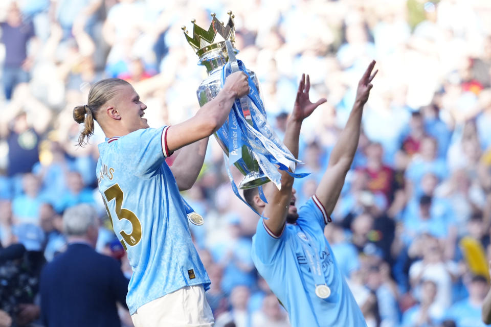 Manchester City's Erling Haaland, left, celebrates Premier League title after the English Premier League soccer match between Manchester City and Chelsea at the Etihad Stadium in Manchester, England, Sunday, May 21, 2023. (AP Photo/Jon Super)