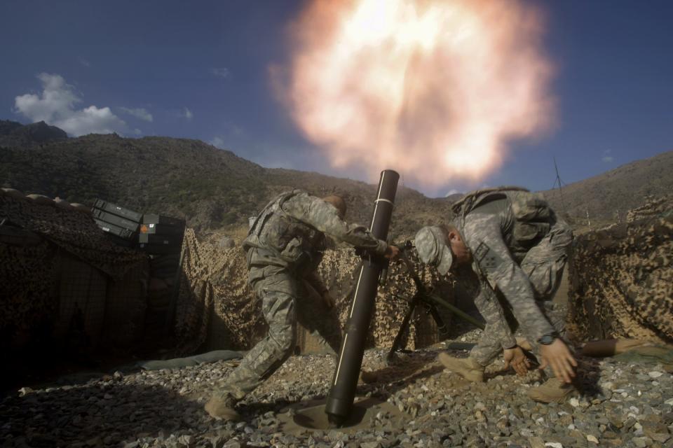 U.S. soldiers from the 2nd Battalion, 12th Infantry Regiment, 4th Brigade Combat Team, fire mortars at known enemy firing positions from a base in the Pech River Valley in Afghanistan's Kunar province, Saturday, Oct. 24, 2009.