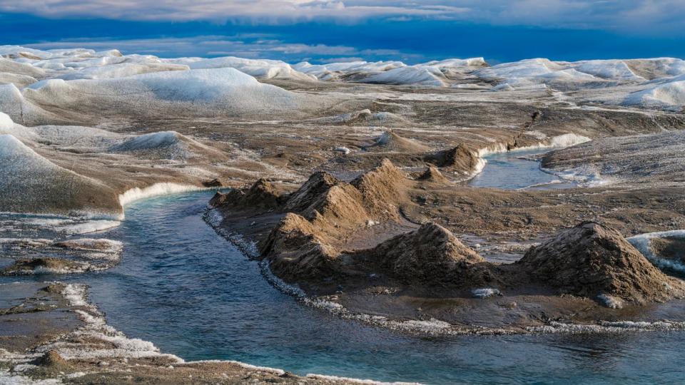 PHOTO: Drainage system with dirt cone on the surface of the ice sheet. The brown sediment on the ice is created by the rapid melting of the ice. Landscape of the Greenland ice sheet near Kangerlussuaq.  (Martin Zwick/REDA&CO/Universal Images Group via Getty Images)