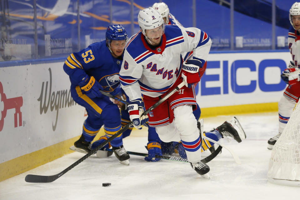 New York Rangers defenseman Jacob Trouba (8) carries the puck during the second period of an NHL hockey game against the Buffalo Sabres, Tuesday, Jan. 26, 2021, in Buffalo, N.Y. (AP Photo/Jeffrey T. Barnes)