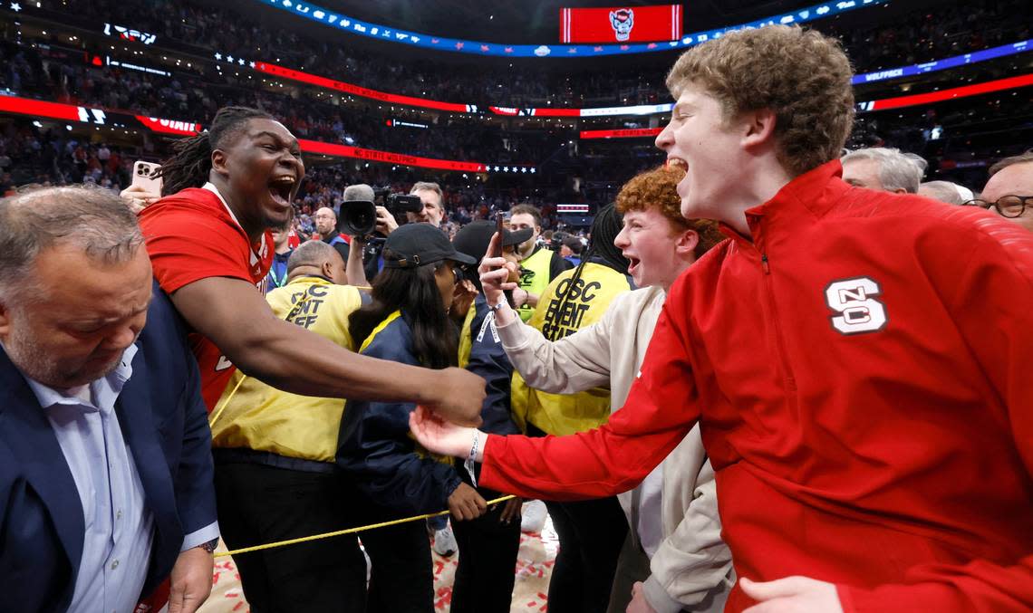 N.C. State’s DJ Burns Jr. (30) celebrates with George Hatem after N.C. State’s 84-76 victory over UNC in the championship game of the 2024 ACC Men’s Basketball Tournament at Capital One Arena in Washington, D.C., Saturday, March 16, 2024.