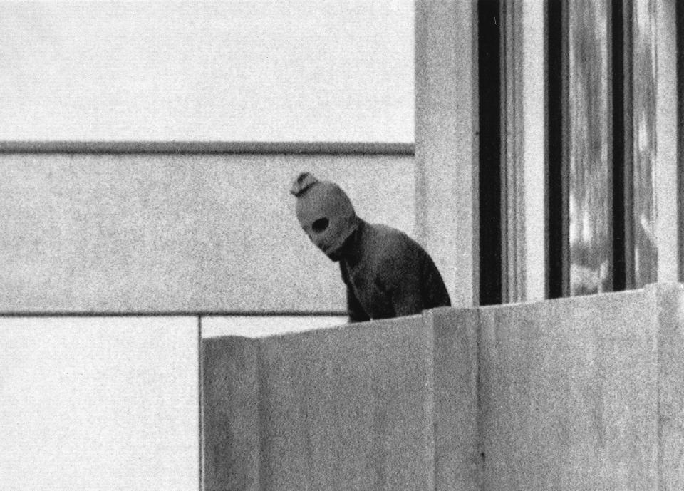 In this Sept. 5, 1972 file photo, a member of the Arab Commando group which seized members of the Israeli Olympic Team at their quarters at the Munich Olympic Village appears with a hood over his face on the balcony of the village building where the commandos held several members of the Israeli team hostage.