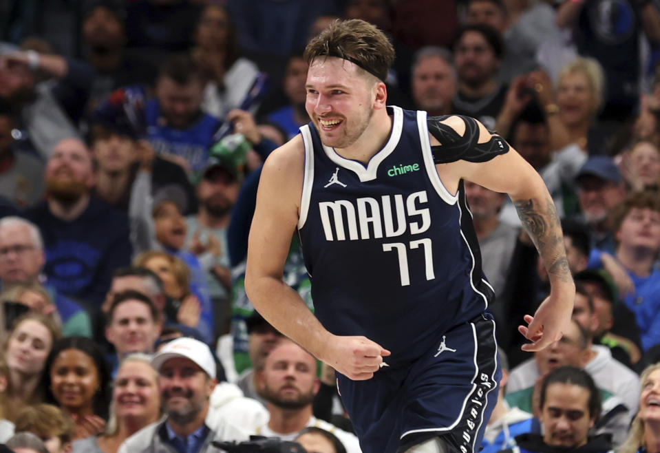 Dallas Mavericks guard Luka Doncic smiles as he runs back up the court after an assist against the San Antonio Spurs during the second half of an NBA basketball game Saturday, Dec. 23, 2023, in Dallas. (AP Photo/Richard W. Rodriguez)