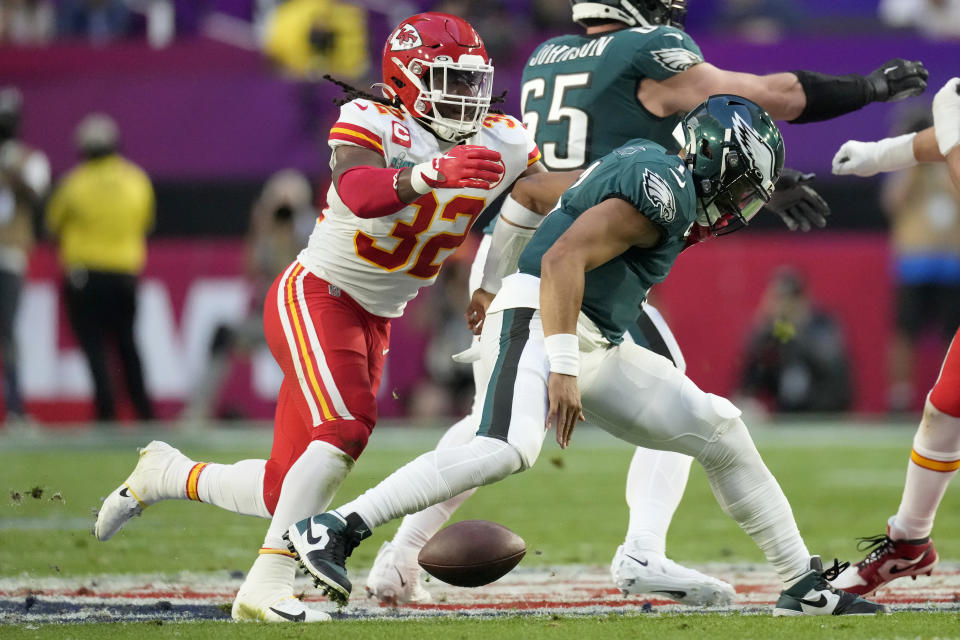 Philadelphia Eagles quarterback Jalen Hurts, right, loses a fumble after being hit by Kansas Phjiladelphia Eagles quarterback Jalen Hurts fumbles as he ihit by Kansas City Chiefs linebacker Nick Bolton (32) during the first half of the NFL Super Bowl 57 football game between the Kansas City Chiefs and the Philadelphia Eagles, Sunday, Feb. 12, 2023, in Glendale, Ariz. Bolton picked up the fumble and scored on the play. (AP Photo/Marcio J. Sanchez)