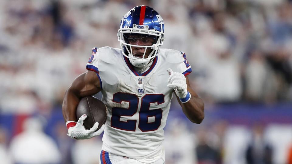 New York Giants running back Saquon Barkley runs the ball in for a touchdown.