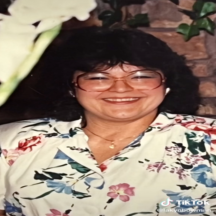 Lakyn's grandma smiles wearing her signature glasses an a fun, floral top