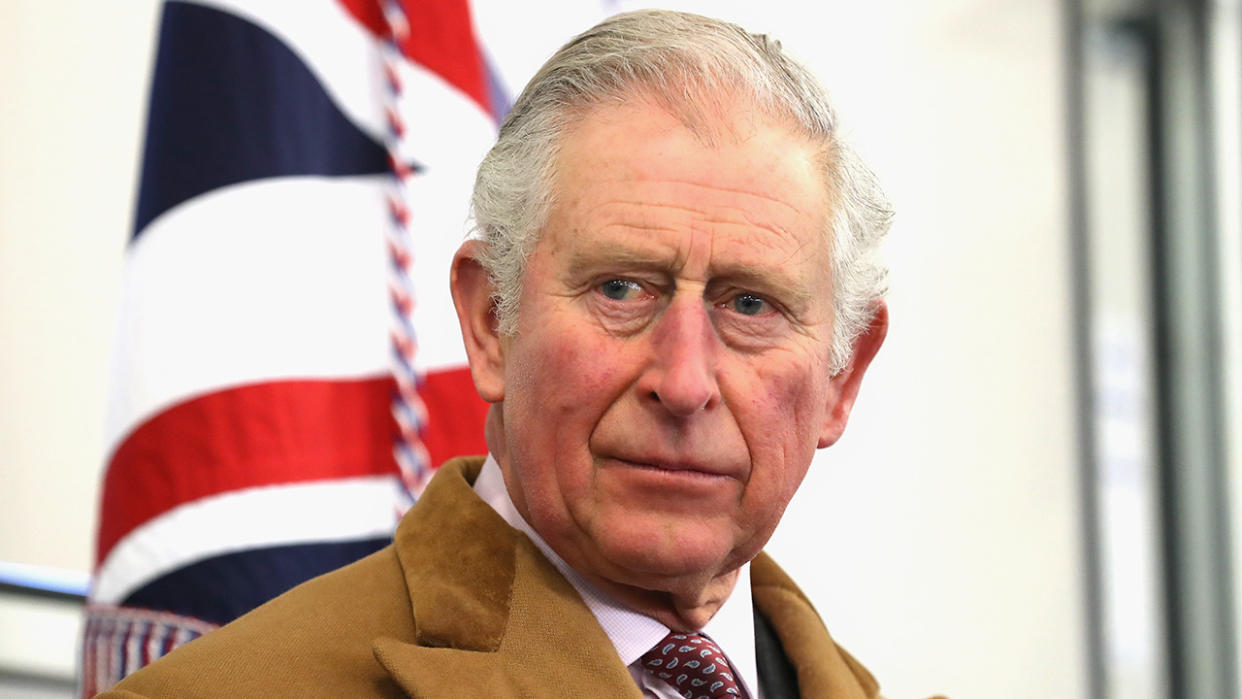  King Charles ahead of 2023 Coronation in front of British flag. 