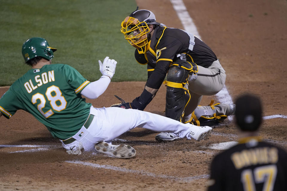 San Diego Padres catcher Austin Nola (22) tags out Oakland Athletics' Matt Olson (28) at home plate during the fourth inning of a baseball game in Oakland, Calif., Friday, Sept. 4, 2020. (AP Photo/Tony Avelar)