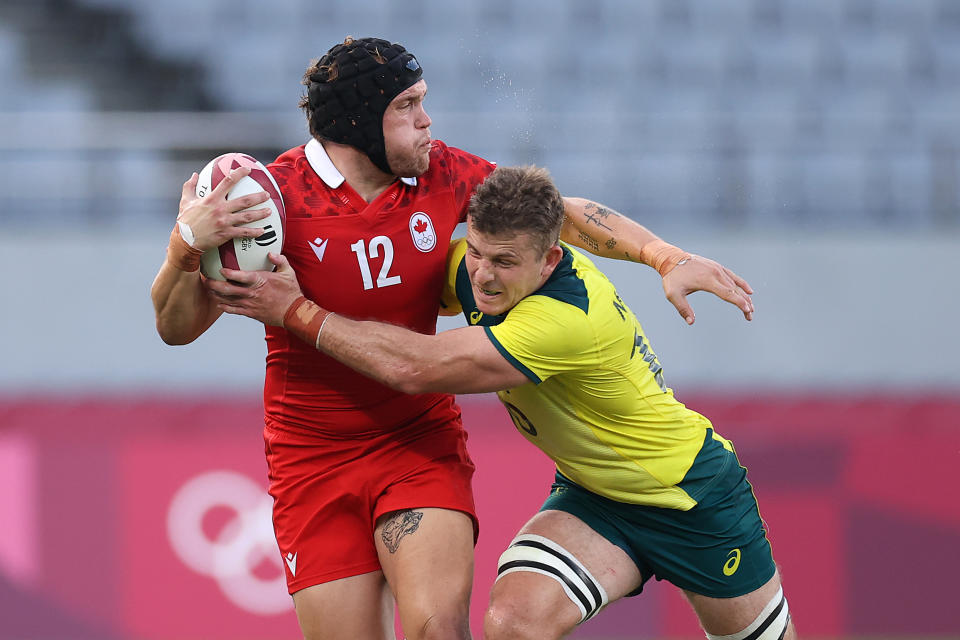 Pictured here, Australia's Nick Malouf tackles a player from Canada at the Olympic Games. 