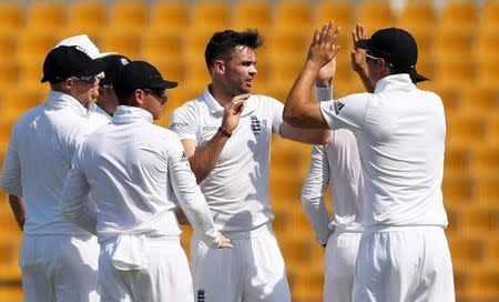 Cricket - Pakistan v England - First Test - Zayed Cricket Stadium, Abu Dhabi, United Arab Emirates - 13/10/15 England's James Anderson (C) celebrates taking the wicket of Pakistan's Shan Masood (not pictured) Action Images via Reuters / Jason O'Brien Livepic