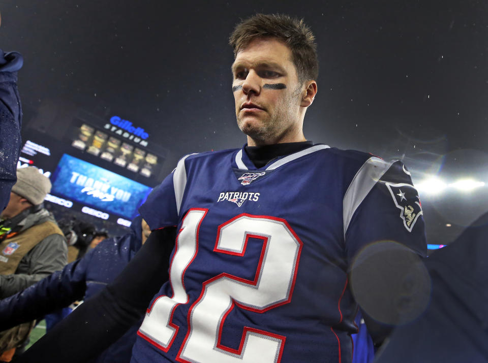 Tom Brady leaves the Gillette Stadium field for the last time as a Patriot after a 2020 playoff loss to the Titans. (Jim Davis/The Boston Globe via Getty Images)
