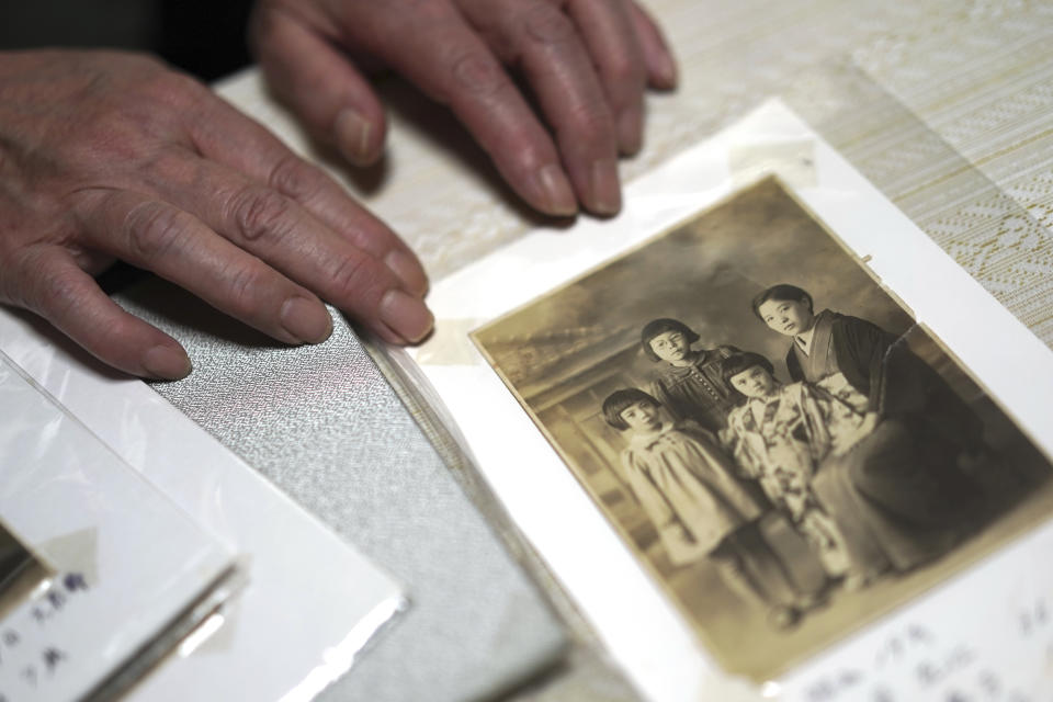 Mari Kaneda, 85, a WWII war orphan, shows a copy of family photo from year of 1944 during an interview with The Associated Press Sunday, July 19, 2020, in Warabi, north of Tokyo. In Japan, war orphans were punished for surviving. They were bullied. They were called trash, sometimes rounded up by police and put in cages. Some were sent to institutions or sold for labor. They were targets of abuse and discrimination. Now, 75 years after the war's end, some are revealing their untold stories of recovery and pain, underscoring Japan’s failure to help its own people. (AP Photo/Eugene Hoshiko)