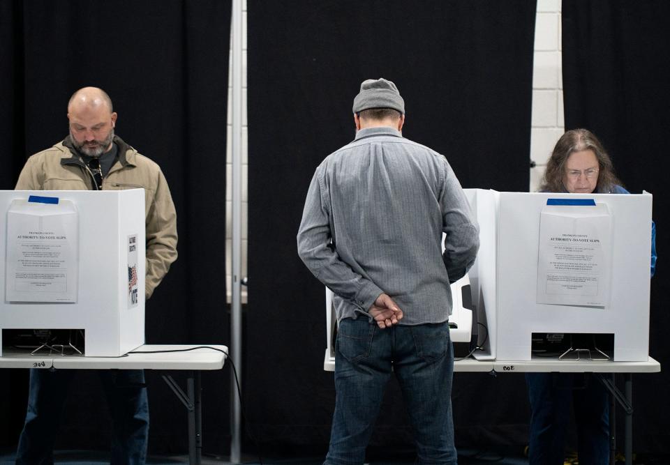 Voters wait in line around 40 minutes to cast their vote Tuesday morning in Clintonville.