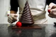 A worker prepares a pastry at the workshop of Belgian chocolate maker Marcolini, in Brussels