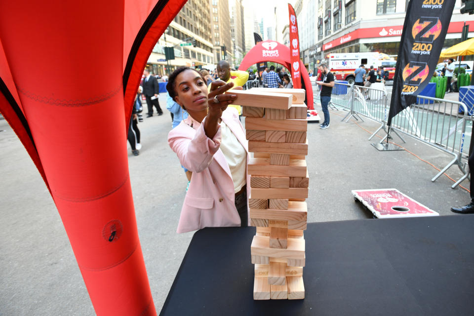 NEW YORK, NEW YORK - SEPTEMBER 27: A guest plays Jenga at iHeartRadio's Z100 Jingle Ball 2019 presented by Capital One® official Kickoff at Herald Square Plaza on September 27, 2019 in New York City. (Photo by Bryan Bedder/Getty Images for iHeartRadio)