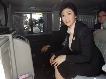 Ousted former Thai Prime Minister Yingluck Shinawatra sits in a van as she leaves the Supreme Court in Bangkok, Thailand, May 19, 2015. REUTERS/Chaiwat Subprasom