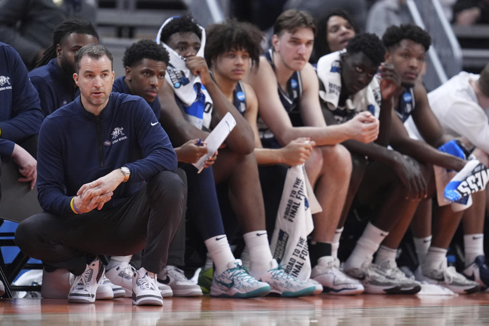 Utah State head coach Danny Sprinkle watches from the sidelines during the second half of a second-round college basketball game against Purdue in the NCAA Tournament, Sunday, March 24, 2024 in Indianapolis. (AP Photo/Michael Conroy)