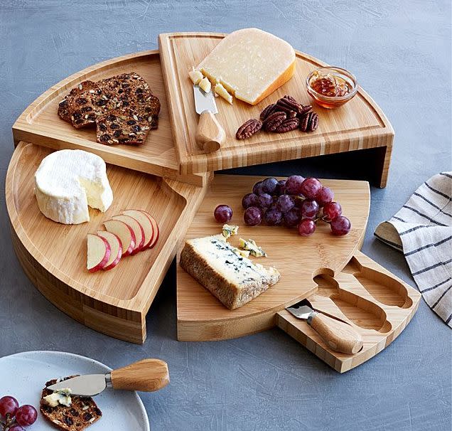 Find this <a href="https://fave.co/3qZeL8a" target="_blank" rel="noopener noreferrer">Compact Swivel Cheese Board with Knives for $42</a> at Uncommon Goods.