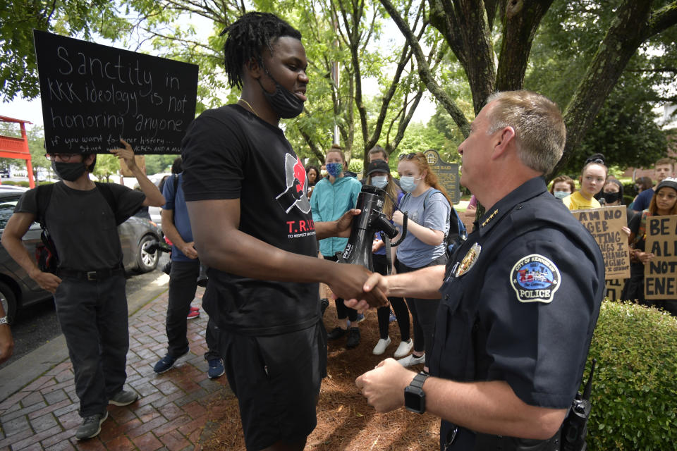 Kennesaw Chief of Police Bill Westenenberger speaks to demonstrators protesting across the street from a Confederate memorabilia store, Friday, June 5, 2020, in Kennesaw, Ga. Protests continued following the death of George Floyd, who died after being restrained by Minneapolis police officers on May 25. (AP Photo/Mike Stewart)