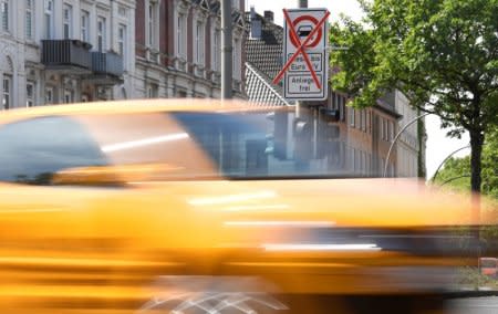 A car passes a traffic sign showing a ban on diesel cars at the Max-Brauer Allee in downtown Hamburg, Germany May 23, 2018. REUTERS/Fabian Bimmer