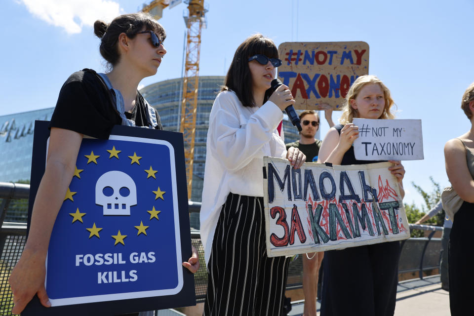 Climate activists demonstrate outside the European Parliament , Tuesday, July 5, 2022 in Strasbourg, eastern France. The European Parliament will decide Wednesday whether to accept or reject the Commission's proposal to classify gas and nuclear power plants as green in the EU's list of investments that can be marketed as sustainable. (AP Photo/Jean-Francois Badias)