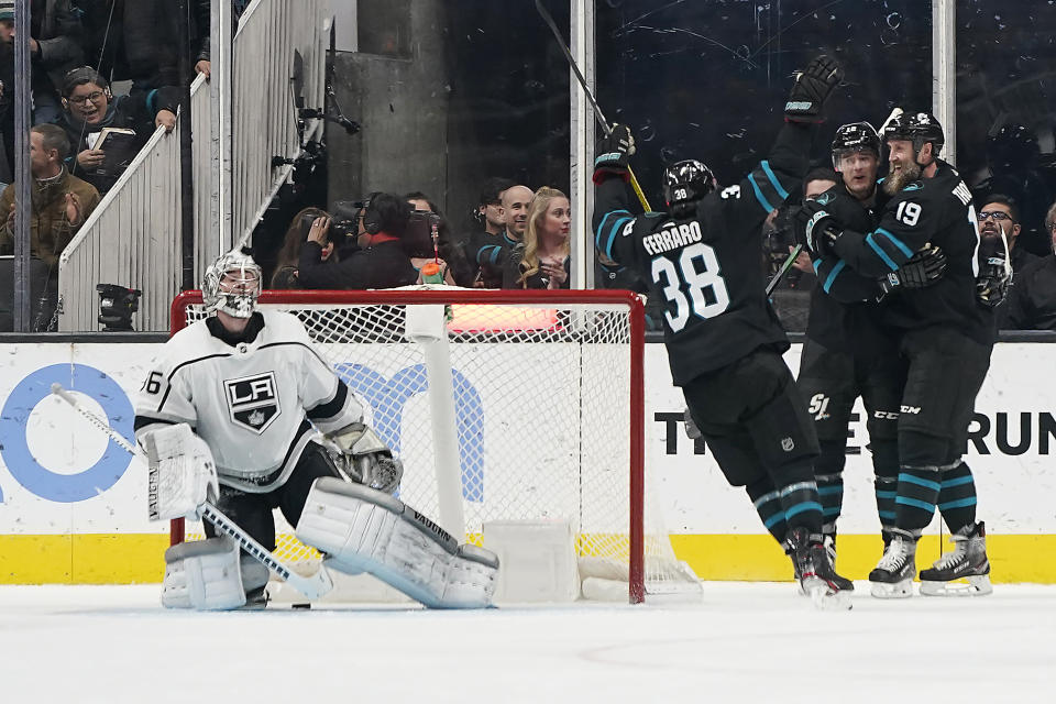 San Jose Sharks center Joe Thornton (19) celebrates his goal with Patrick Marleau, center, and Mario Ferraro (38) as Los Angeles Kings goaltender Jack Campbell (36) looks on during the second period of an NHL hockey game in San Jose, Calif., Friday, Dec. 27, 2019. (AP Photo/Tony Avelar)