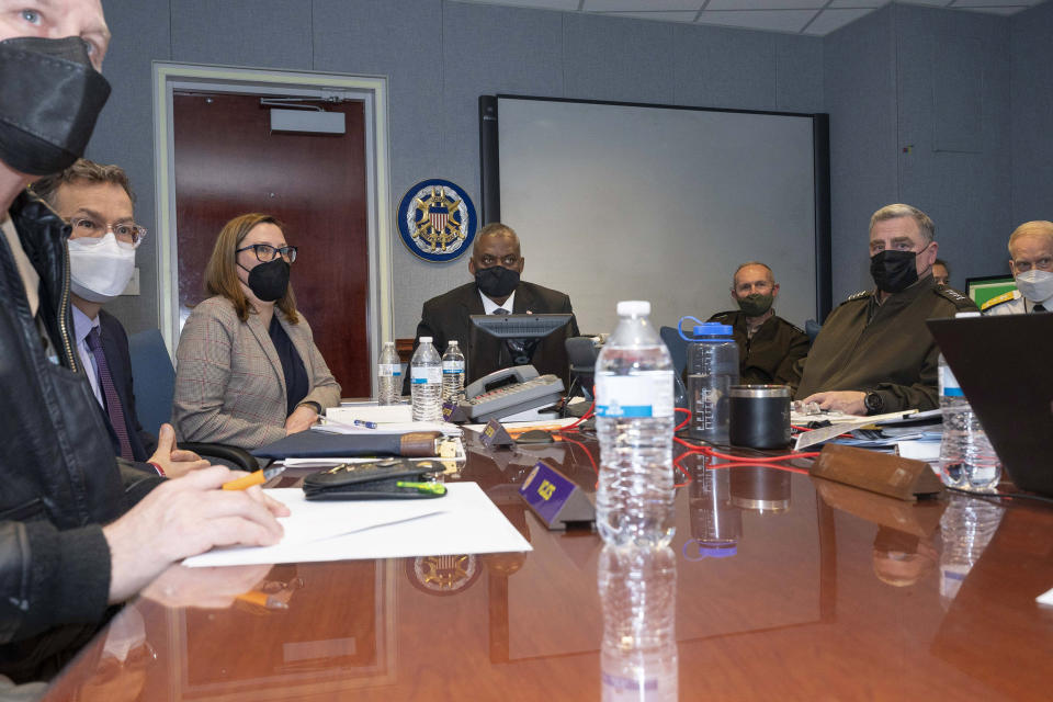 In this image provided by the Department of Defense, Secretary of Defense Lloyd Austin and Chairman of the Joint Chiefs of Staff Gen. Mark Milley, second from right, observe the U.S. raid in Syria against Islamic State group leader Abu Ibrahim al-Hashimi al-Qurayshi, from the National Military Command Center in the Pentagon in Washington, on Wednesday, Feb. 2, 2022. (Lisa Ferdinando/Department of Defense via AP)