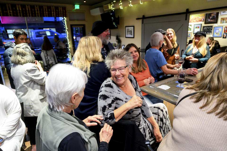 Sandy Miller speaks with Nic's Deli & Wine Bar owner Nikki Jones, left, Wednesday, Oct. 25, 2023, in Paradise, Calif. Jones lost two businesses in 2018's Camp Fire. (AP Photo/Noah Berger)
