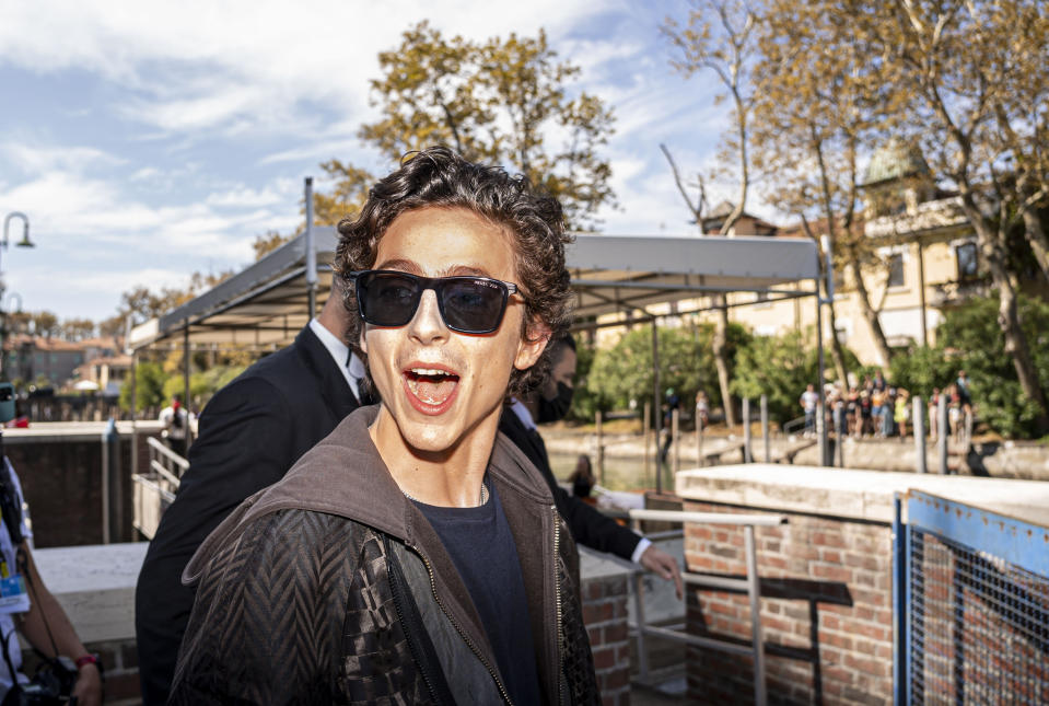 Actor Timothée Chalamet reacts to fans upon his arrival for the photo call of the film 'Dune' at the 78th edition of the Venice Film Festival in Venice, Italy, Friday, Sep, 3, 2021. (AP Photo/Domenico Stinellis)