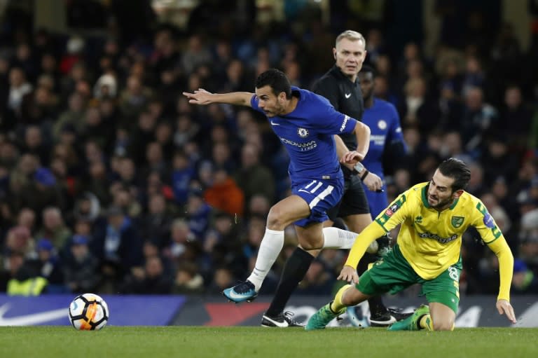 Chelsea midfielder Pedro (L) gets away from Norwich City midfielder Mario Vrancic during the FA Cup third round replay at Stamford Bridge in London on January 17, 2018