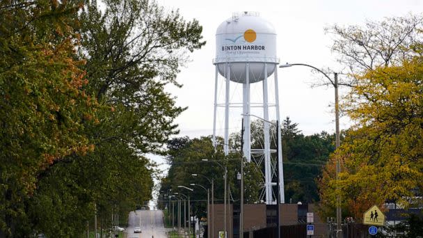 PHOTO: A lone resident of Benton Harbor, Mich., walks across Britain Street Friday, Oct. 22, 2021, near the city's water tower in Benton Harbor. (Charles Rex Arbogast/AP, FILE)