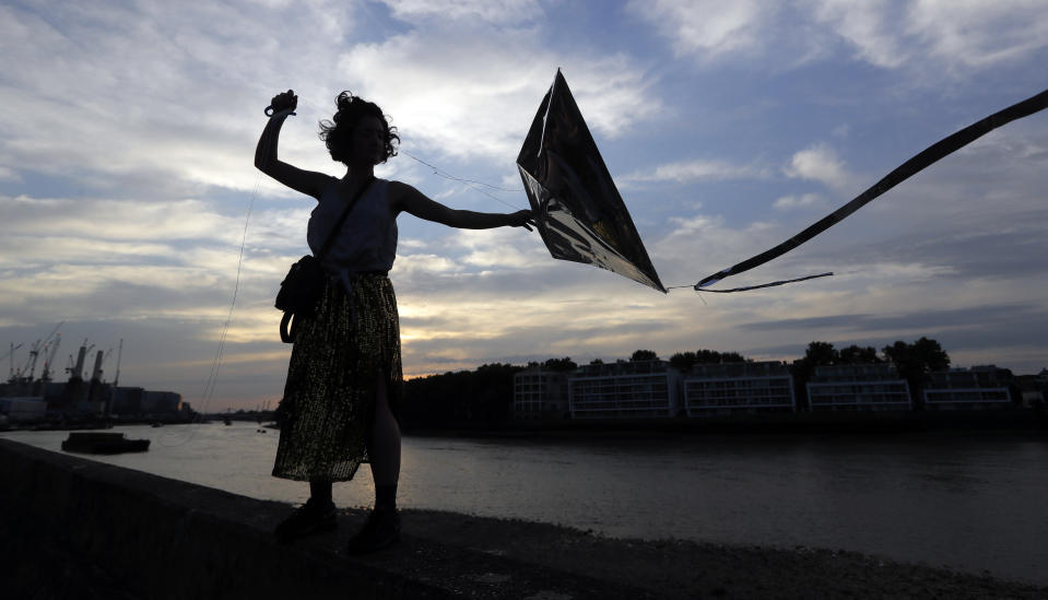 <p>Artist Gabriela Hirst flies a kite for an art installation called ‘Preliminary Attempts to Rearrange a Sunset’, a shifting installation in the sky on the bank of the River Thames in London, Thursday, Aug. 23, 2018. (AP Photo/Kirsty Wigglesworth) </p>