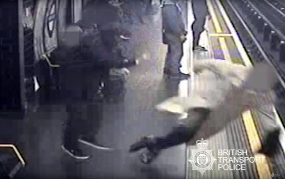 This undated handout grab taken from CCTV issued by British Transport Police shows Robert Malpas being pushed on to the tracks of Marble Arch Underground station in London. A man has been convicted of attempted murder for pushing the former chairman of cross-Channel tunnel operator Eurotunnel onto London subway tracks. A jury found Paul Crossley guilty Friday, Oct. 5, 2018 of shoving 91-year-old Robert Malpas off a platform at Marble Arch station in April. Malpas suffered a fractured pelvis and a gash to his head. (British Transport Police via AP)