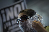 <p>An activist protests on the first day of the the partial reinstatement of the Trump travel ban, temporarily barring travelers from six Muslim-majority nations from entering the U.S., at Los Angeles International Airport (LAX) on June 29, 2017 in Los Angeles, California. (David McNew/Getty Images) </p>