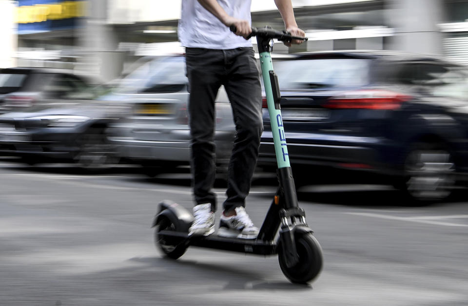 A man drives an electric pedal scooter from Tier in Berlin, Germany. | Britta Pedersen—picture-alliance/dpa/AP