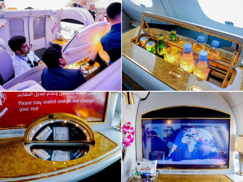 Emirates first class stitch of the closed pod, mini-bar, vanity, and TV with the world map on it.