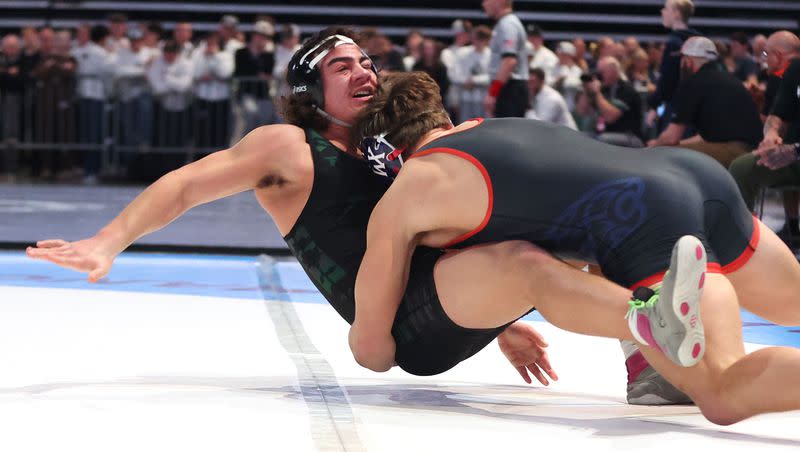 Cash Henderson, Woods Cross, beats Lione Hola, Kearns, at 215 pounds in the 5A boys wrestling state championships at UVU in Orem on Saturday, Feb. 17, 2024.