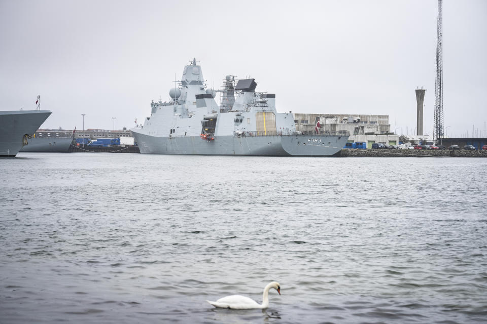 A swan swims as the Danish frigate HDMS Niels Juel, number F363, is docked in Korsoer, Denmark, Thursday, April 4, 2024. Denmark's Armed Forces said a technical problem arose with a Harpoon missile on board the Danish frigate HDMS Niels Juel as it was taking part in a test while anchored in the Korsoer naval base. (Emil Nicolai Helms/Ritzau Scanpix via AP)