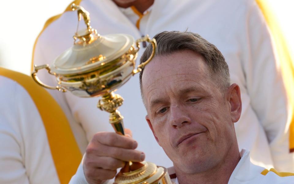 Europe's Team Captain Luke Donald holds and looks at the list of winner engraved on the Ryder Cup trophy