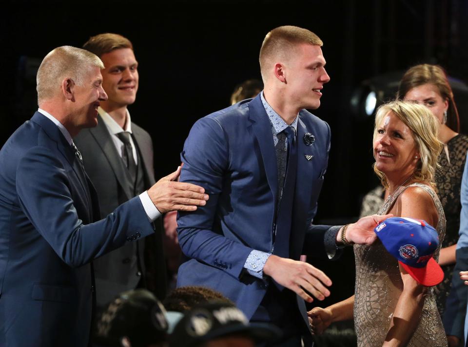 <p>Henry Ellenson, center, is congratulated by friends and family after being selected 18th overall by the Detroit Pistons during the NBA basketball draft, Thursday, June 23, 2016, in New York. (AP Photo/Frank Franklin II) </p>