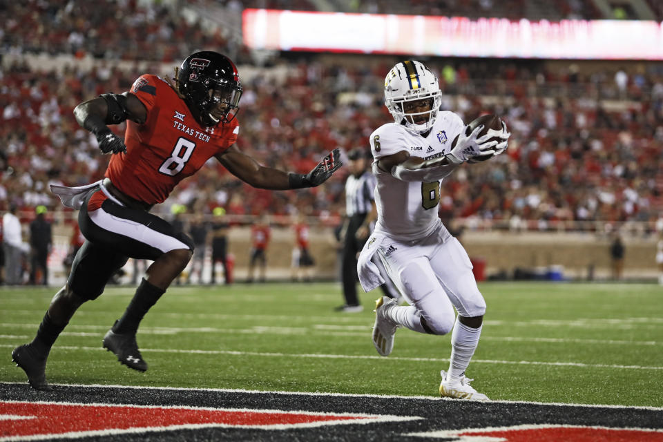 Florida International's Nate Jefferson (6) scores a touchdown around Texas Tech's Malik Dunlap (8) during the second half of an NCAA college football game on Saturday, Sept. 18, 2021, in Lubbock, Texas. (AP Photo/Brad Tollefson)