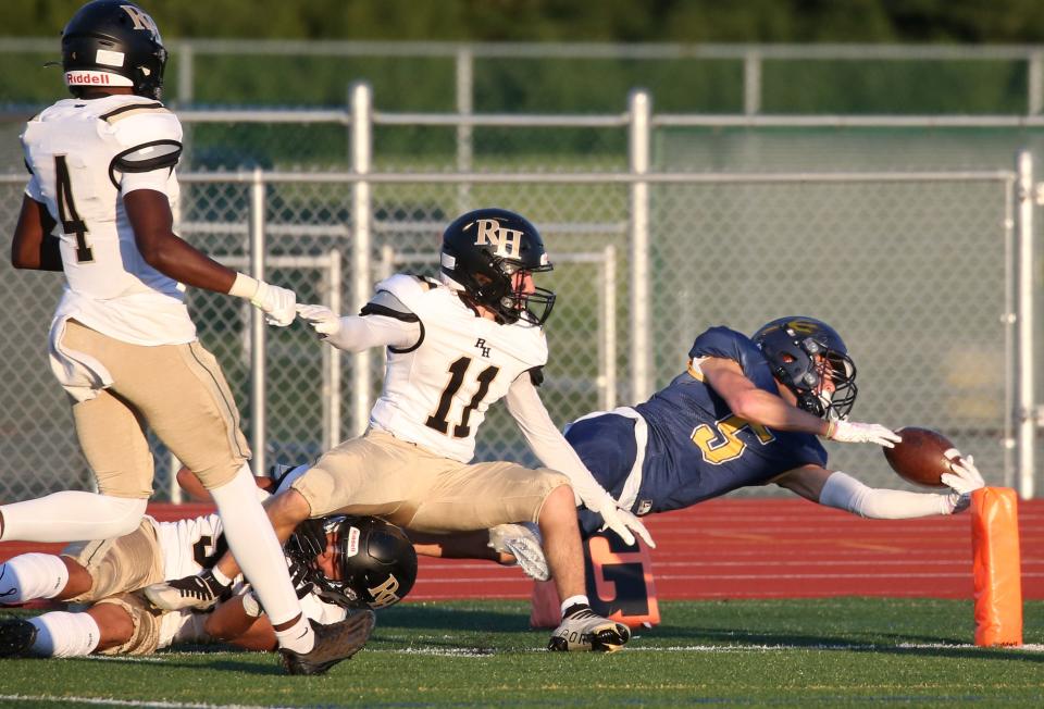 Victor's Adam Ruffalo dives for the end zone marker but is pushed out of bounds by a trio of Rush-Henrietta defenders, Brendan Mangone (11), Ronin Walker (52) and Nasir Patton (4), setting up first in goal.
