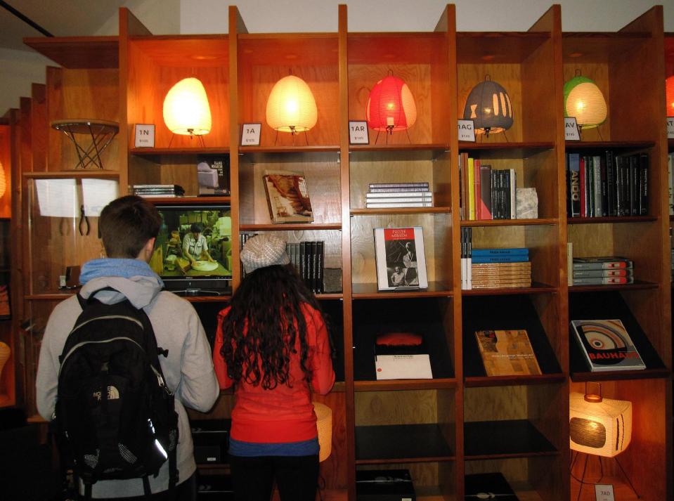 In this April 20, 2013 photo, lamps designed by the late sculptor Isamu Noguchi are displayed on shelves at the gift shop of the Noguchi Museum in Long Island City, N.Y. Japanese lanterns used for ancestor worship inspired Noguchi to design the lamps, which he called akari, the Japanese word for light. His widely imitated designs became classics of mid-20th century modern home design and the original designs are still sold by the Noguchi Museum and Foundation. (AP Photo/Beth J. Harpaz)