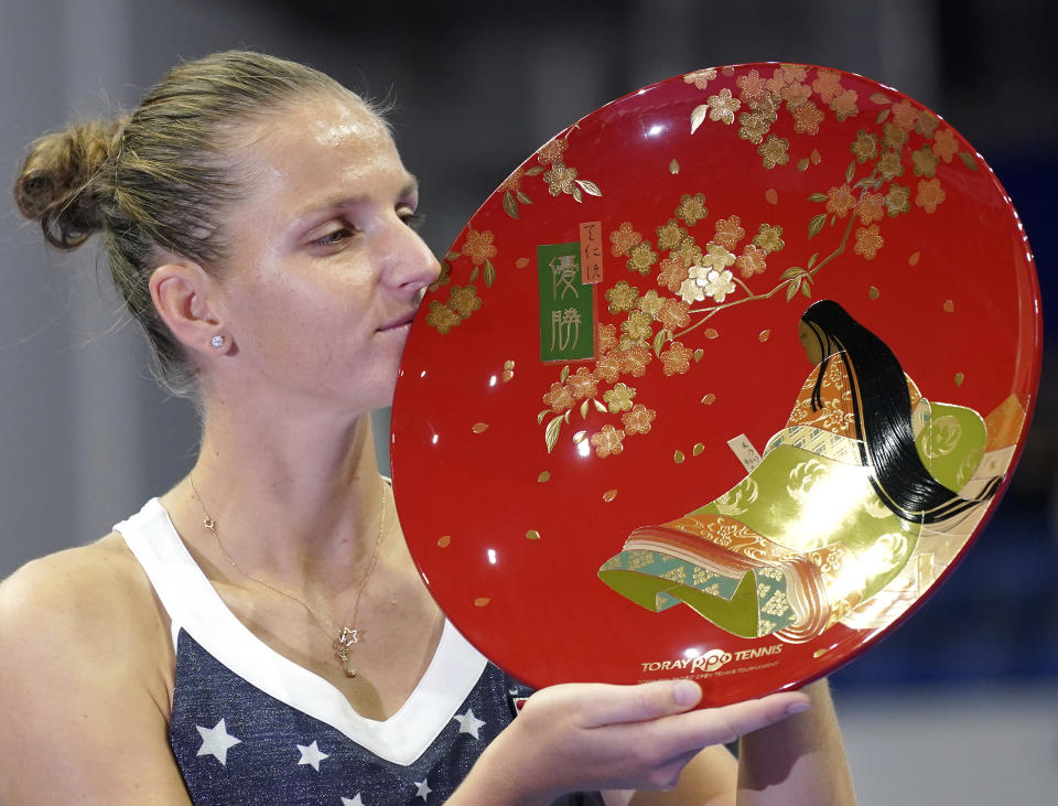 CORRECTS FIRST NAME OF OSAKA - Karolina Pliskova, of Czech Republic kisses her champion trophy during the award ceremony of the Pan Pacific Open women's tennis tournament in Tokyo Sunday, Sept. 23, 2018. Pliskova won over Naomi Osaka of Japan in the final, 6-4, 6-4. (AP Photo/Eugene Hoshiko)