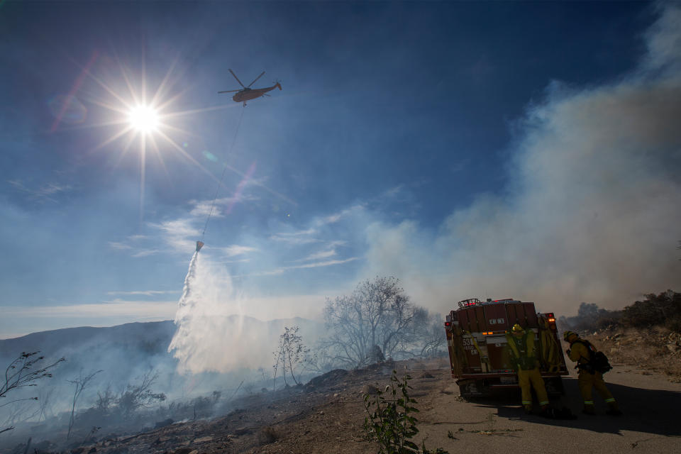 <p>A helicopter makes a water drop on the Thomas Fire on December 7 near Fillmore, California.</p>